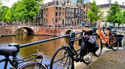 amsterdam canal scene with bicycles and bridges