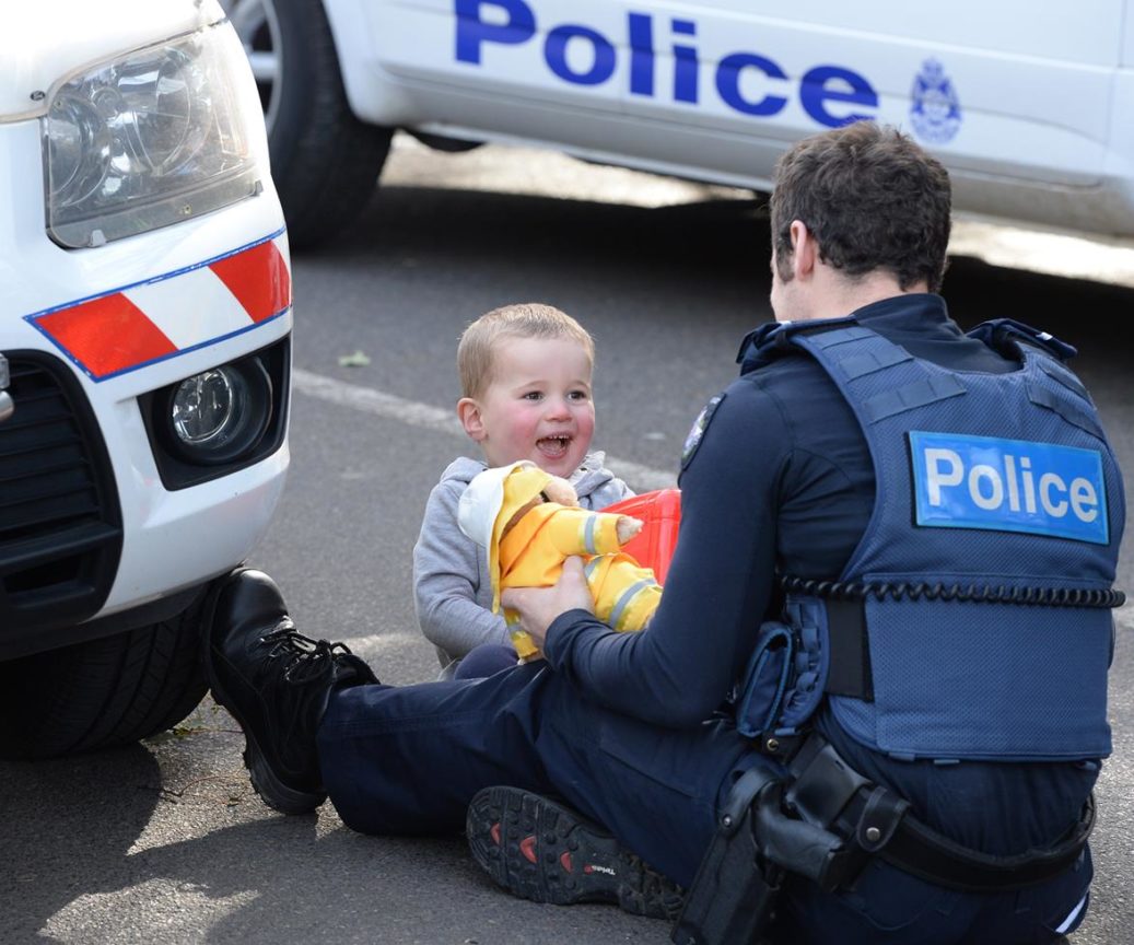 police officer distracts little boy