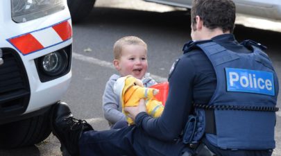 police officer distracts little boy