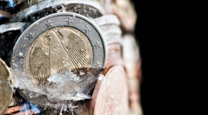 shiny euro coins frozen in ice with german coin in front MJ4F sR