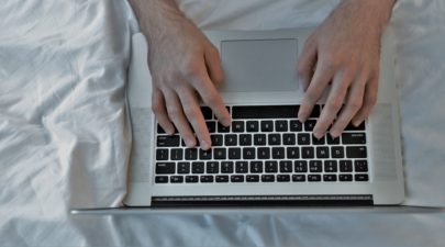 graphicstock top view of man using laptop and lying on bed HuMBUp8ne