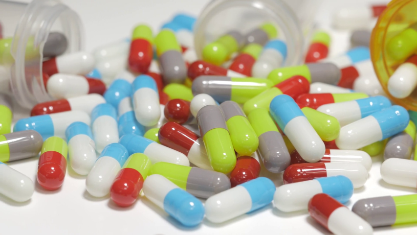 videoblocks 4k drugs medication pills capsules on a white table closeup rzc3s9n9x thumbnail full08