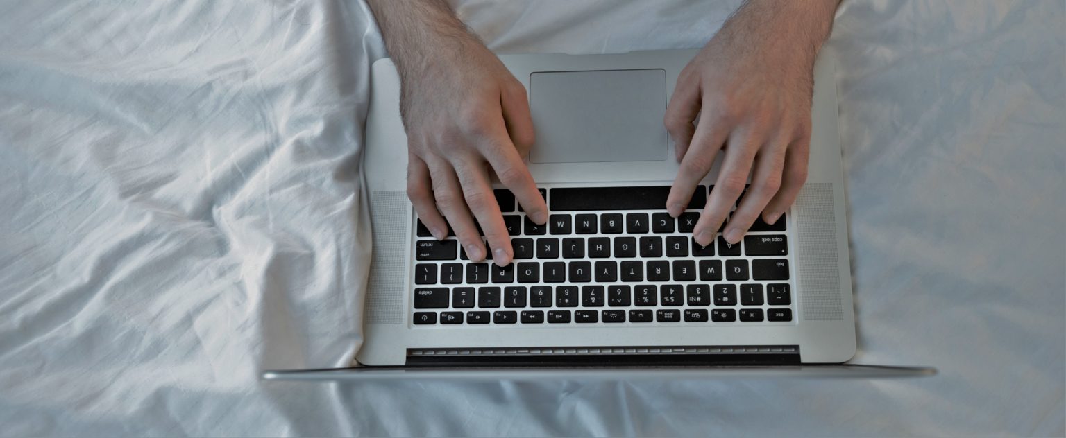 graphicstock top view of man using laptop and lying on bed HuMBUp8ne